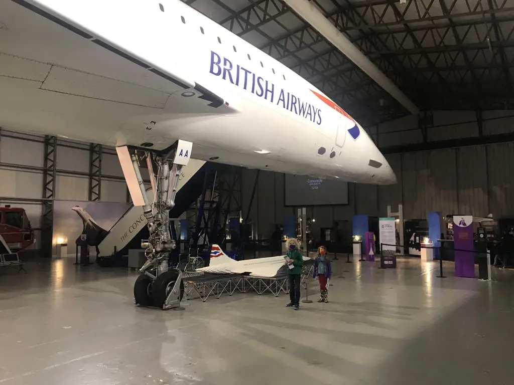 children standing under the concord at the National Museum of Flight with a Lego concord beside them