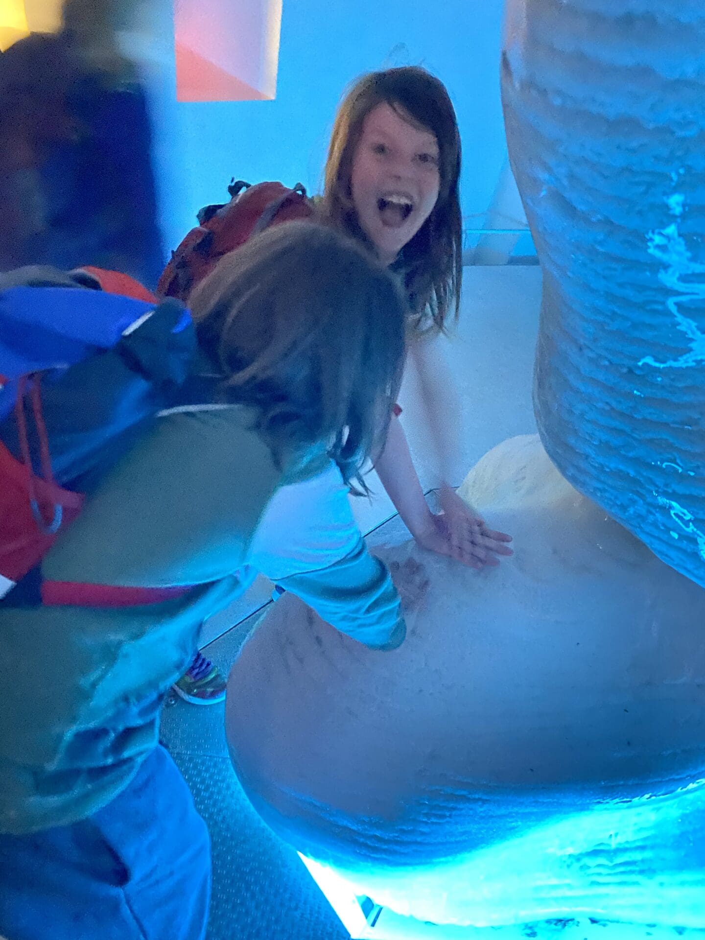 Children touching an iceberg